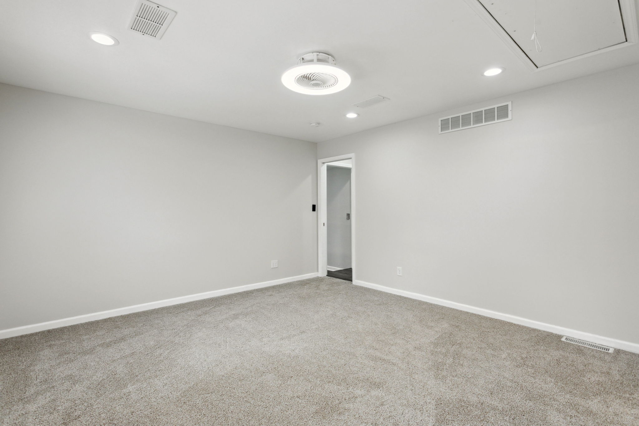 After: Renovated bedroom with new carpet and modern ceiling fixture — 19776 Gilmer South Bend