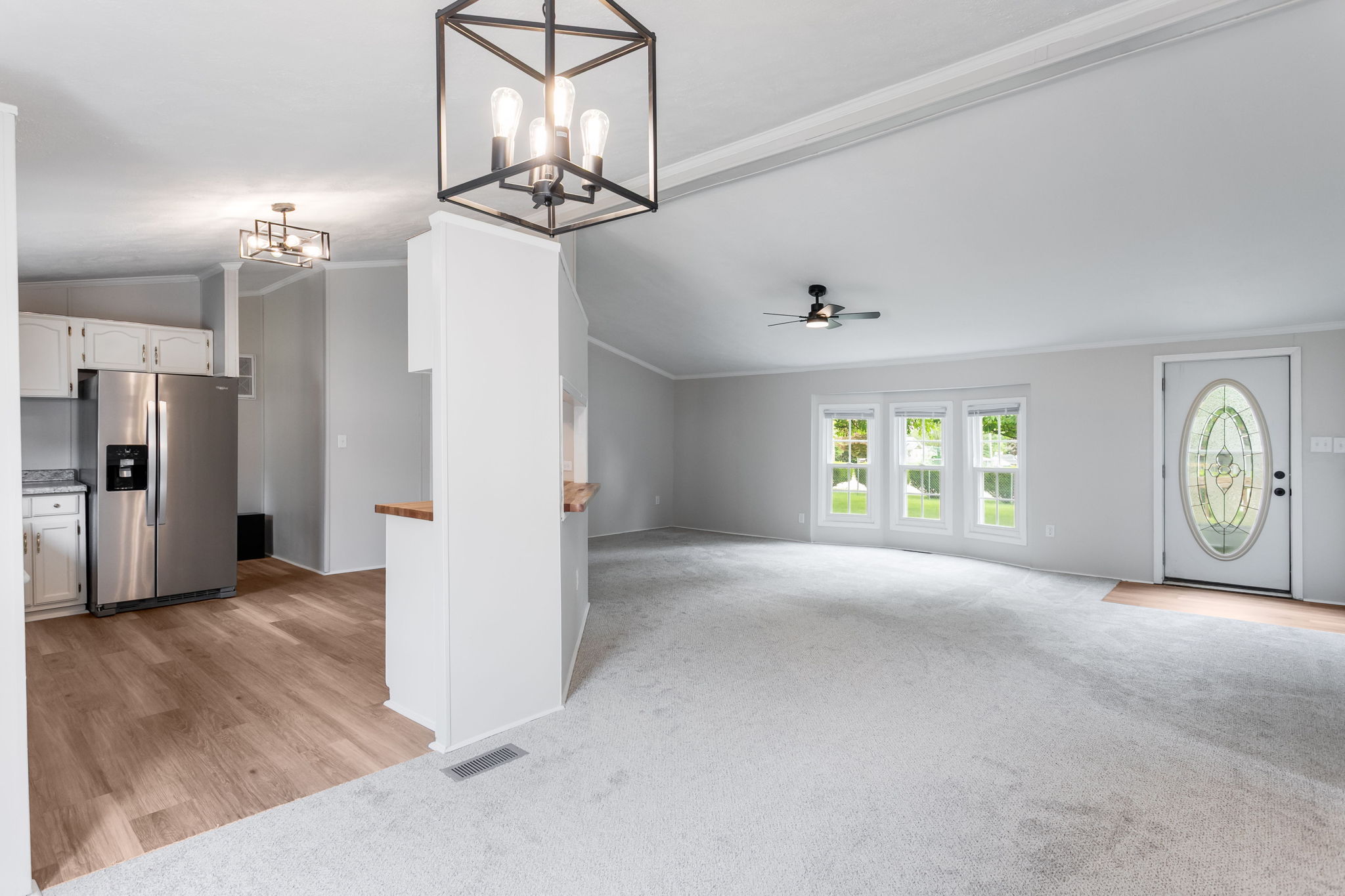 After: Open living room with new LVP and updated lighting — 2715 Ewing Mishawaka