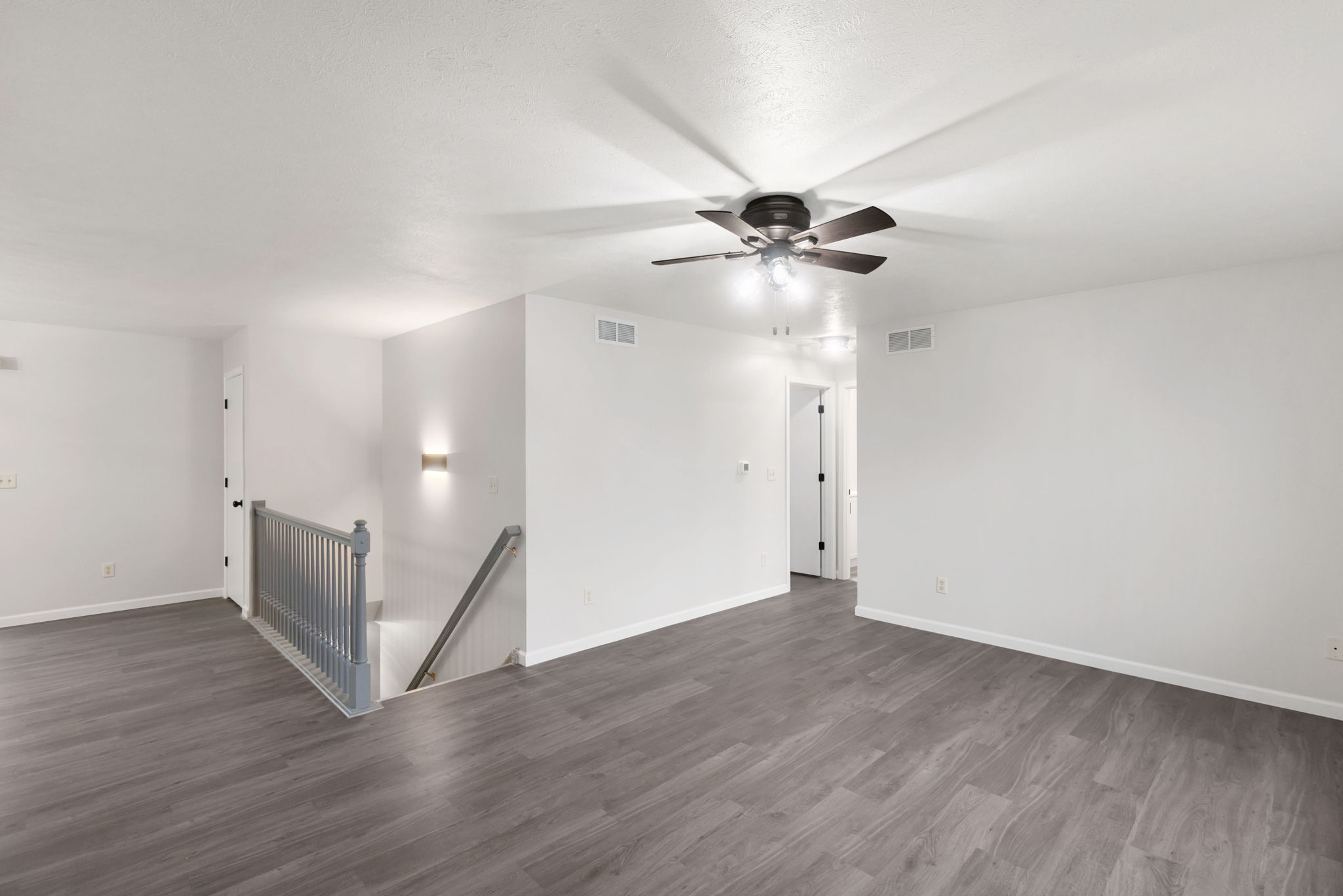 After: Open upper living area with new LVP throughout — 2915 Leana Goshen