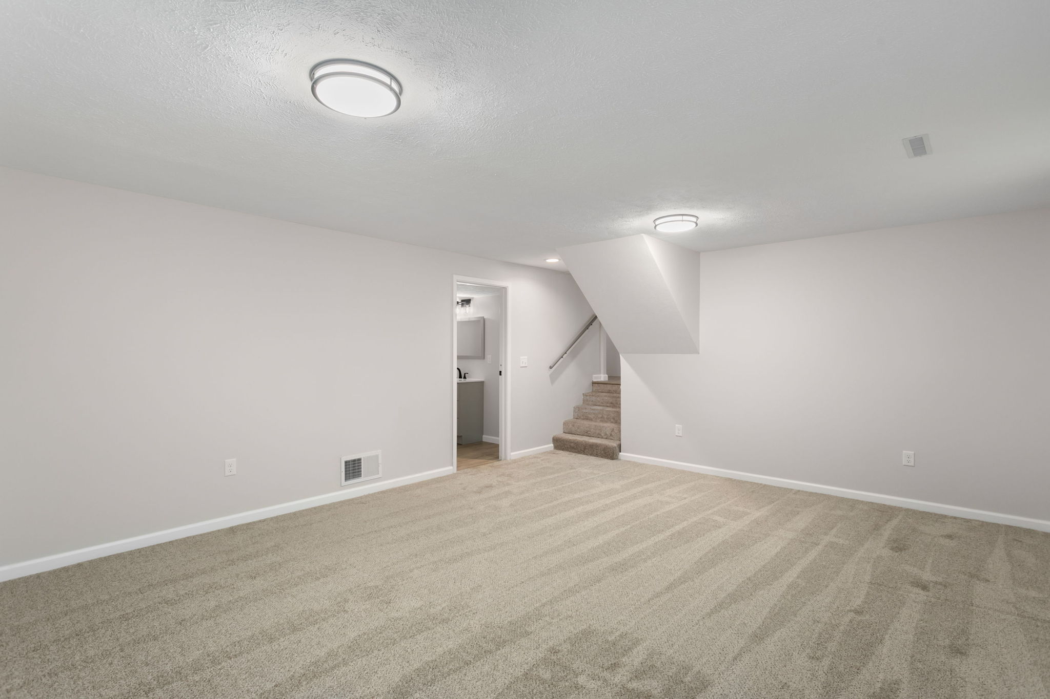 After: Lower level family room with new carpet — 4334 Coral South Bend