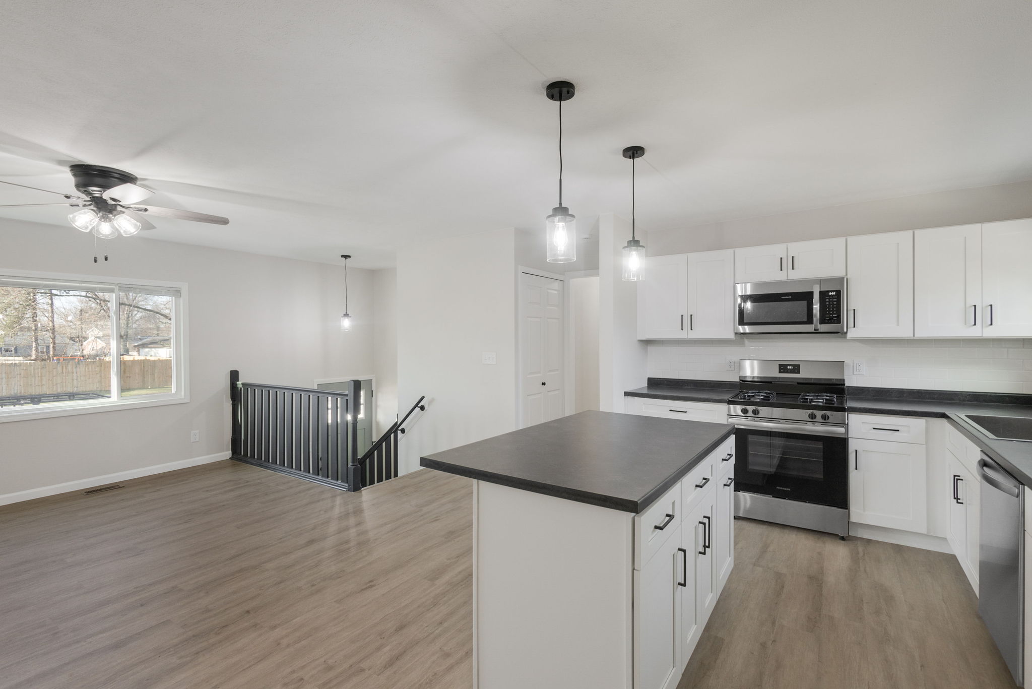 After: Renovated kitchen with white shaker cabinets and new LVP โ 4920 Blackford South Bend