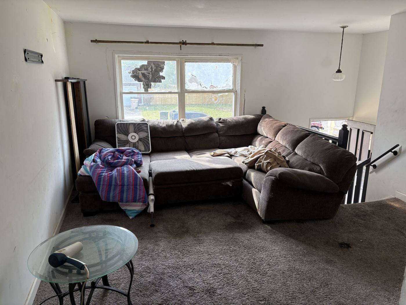Before: Living area with broken window โ 4920 Blackford South Bend