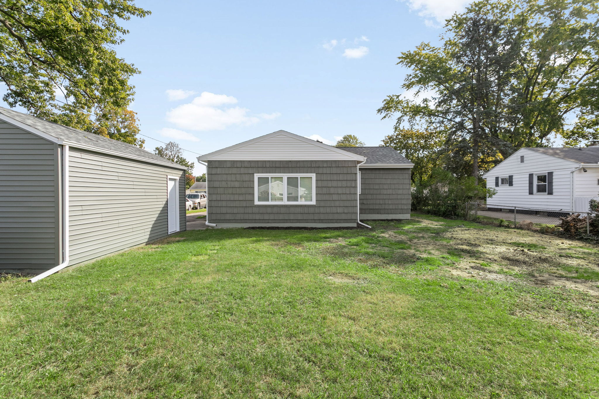 After: Rear exterior with new siding and garage — 54611 28th St. South Bend