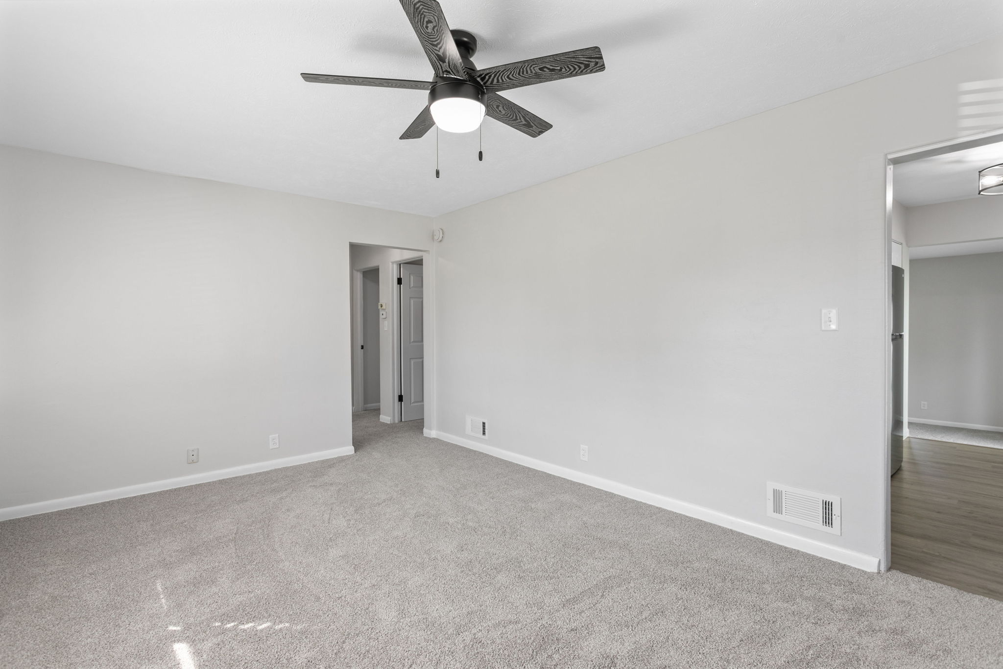 After: Bedroom with new carpet and updated ceiling fan — 54611 28th St. South Bend