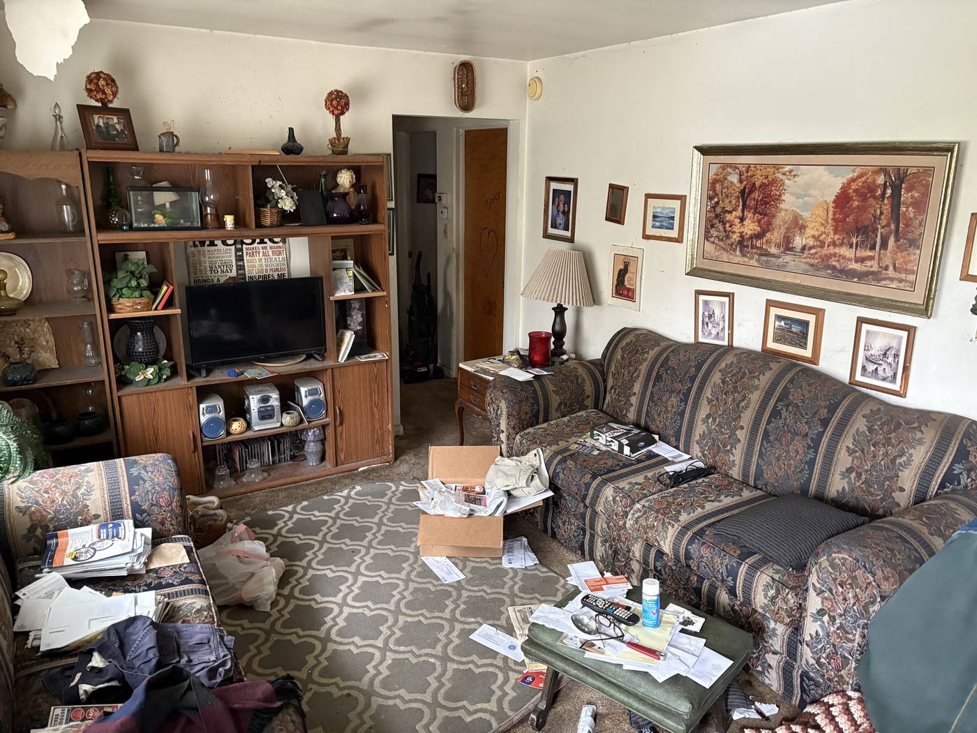 Before: Living room with lifetime of belongings — 54611 28th St. South Bend