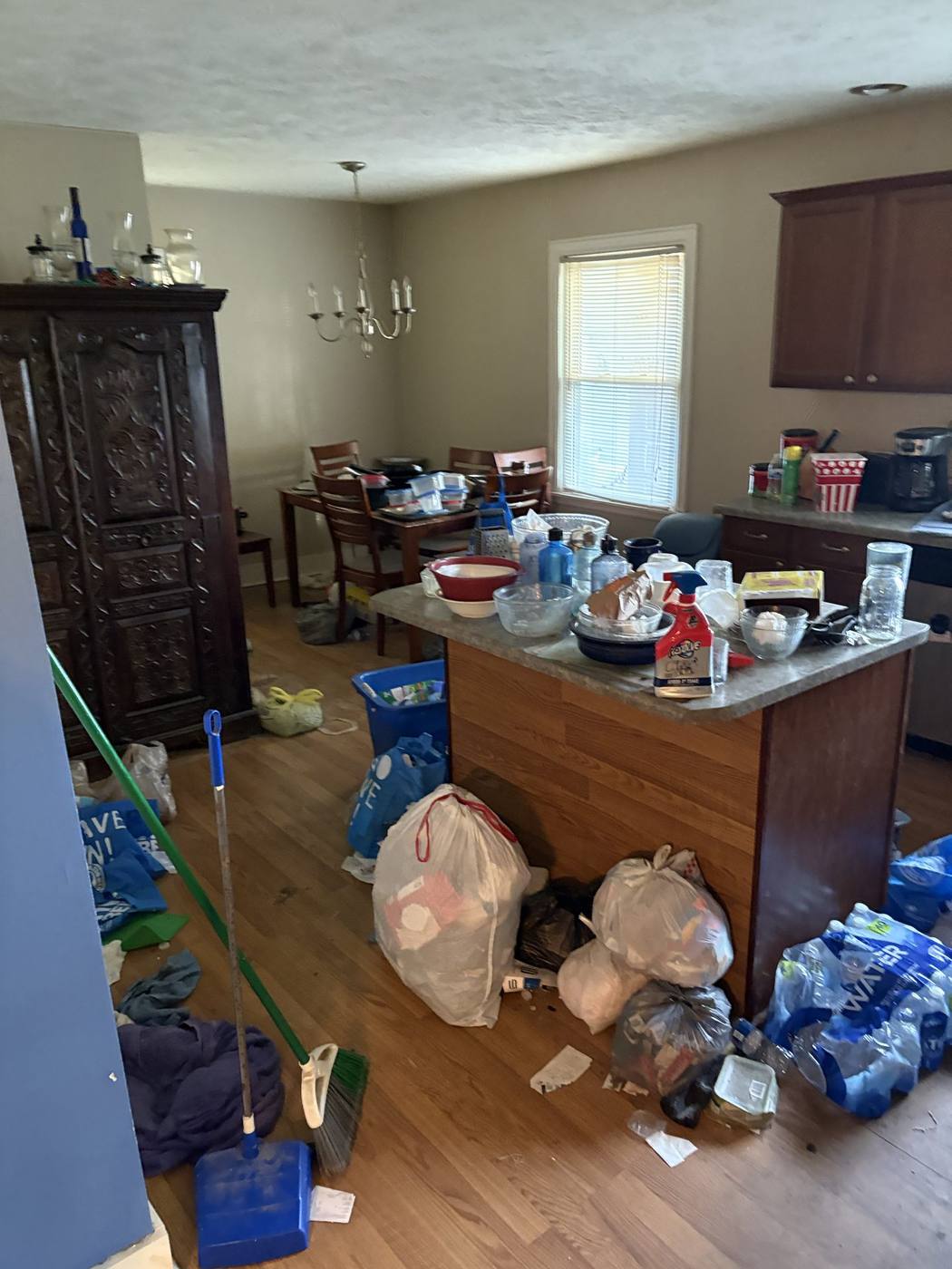 Before: Living/dining area with accumulated contents — 705 E. Lowell Mishawaka